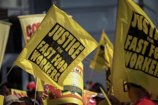 Fast food workers rally through the streets of Sacramento on Aug. 31, 2023. Photo by Rahul Lal for CalMatters