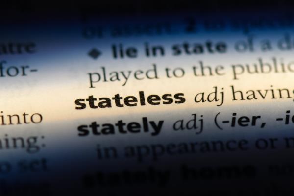 A close-up of the word 'stateless' in the dictionary